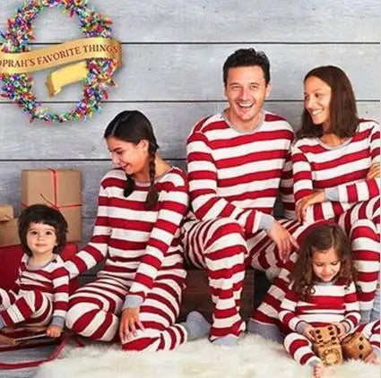 Christmas family matching pajamas set featuring striped designs for mom, kids, and baby.